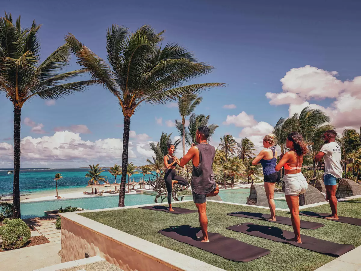Long Beach A Sun Resort_Yoga-Group-Lawn-Pool.webp